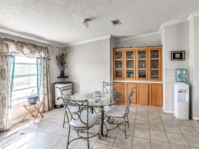 19108 Finn Ridge Rd, Purcell, OK 73080 - dining area featuring crown molding, light tile patterned floors, a textured ceiling, baseboards, and a textured wall