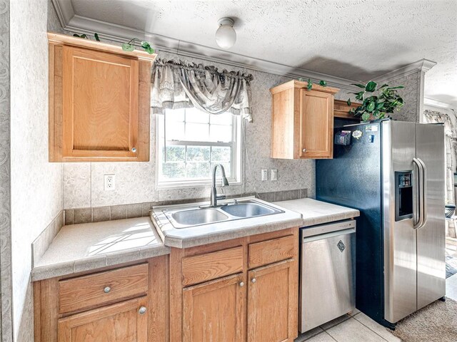 19108 Finn Ridge Rd, Purcell, OK 73080 - kitchen with appliances with stainless steel finishes, crown molding, a sink, a textured ceiling, and wallpapered walls