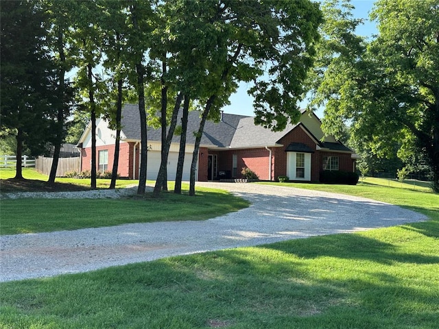 12 Northwood Dr, Shawnee, OK 74804 - view of front of home with curved driveway and brick siding