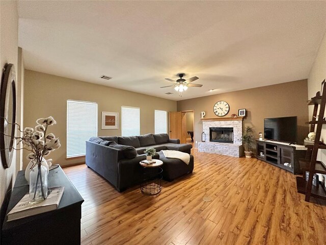 12 Northwood Dr, Shawnee, OK 74804 - living room featuring light wood-style floors, ceiling fan, and a brick fireplace