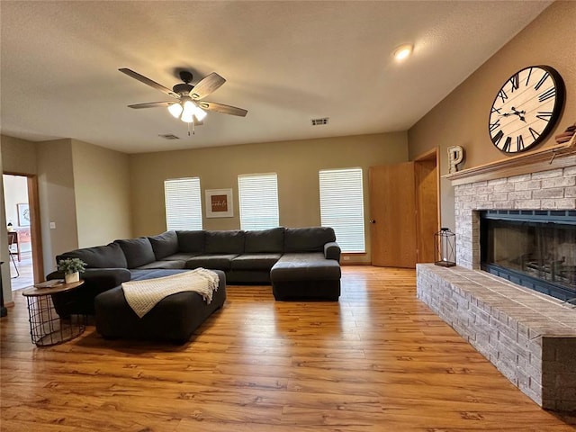 12 Northwood Dr, Shawnee, OK 74804 - living room featuring ceiling fan, wood finished floors, and a brick fireplace