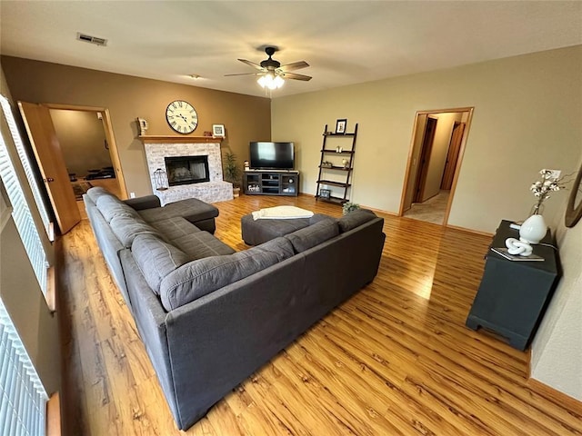 12 Northwood Dr, Shawnee, OK 74804 - living room featuring light wood-style flooring, ceiling fan, and a fireplace