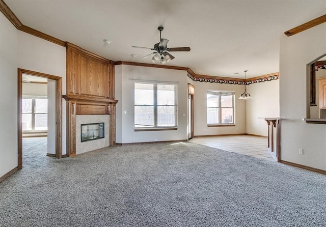 5704 Bent Creek Dr, Oklahoma City, OK 73135 - unfurnished living room featuring a ceiling fan, crown molding, light carpet, a high end fireplace, and baseboards