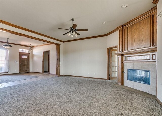 5704 Bent Creek Dr, Oklahoma City, OK 73135 - unfurnished living room with light colored carpet, ornamental molding, ceiling fan, a fireplace, and baseboards