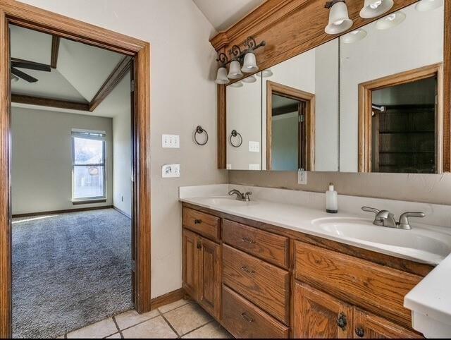 5704 Bent Creek Dr, Oklahoma City, OK 73135 - bathroom featuring double vanity, tile patterned flooring, lofted ceiling, baseboards, and ceiling fan