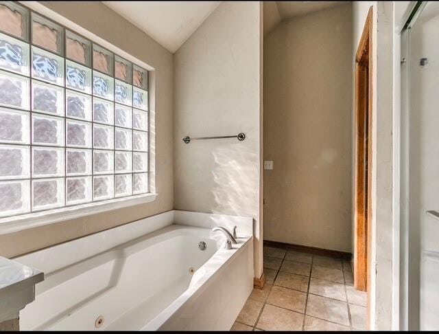 5704 Bent Creek Dr, Oklahoma City, OK 73135 - bathroom with a tub with jets and tile patterned flooring