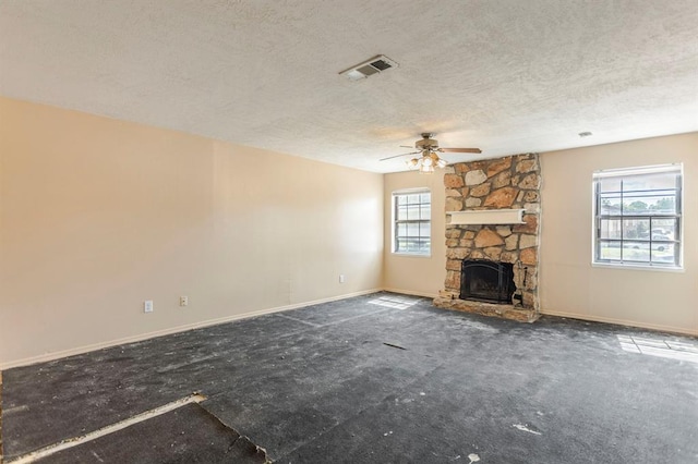 2604 N Ann Arbor Ave Unit 224, Oklahoma City, OK 73127 - unfurnished living room featuring a textured ceiling, ceiling fan, and a fireplace