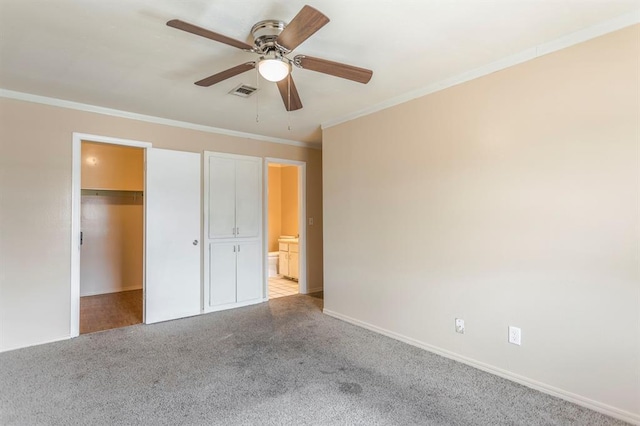 2604 N Ann Arbor Ave Unit 224, Oklahoma City, OK 73127 - unfurnished bedroom with carpet floors, crown molding, a walk in closet, a closet, and a ceiling fan