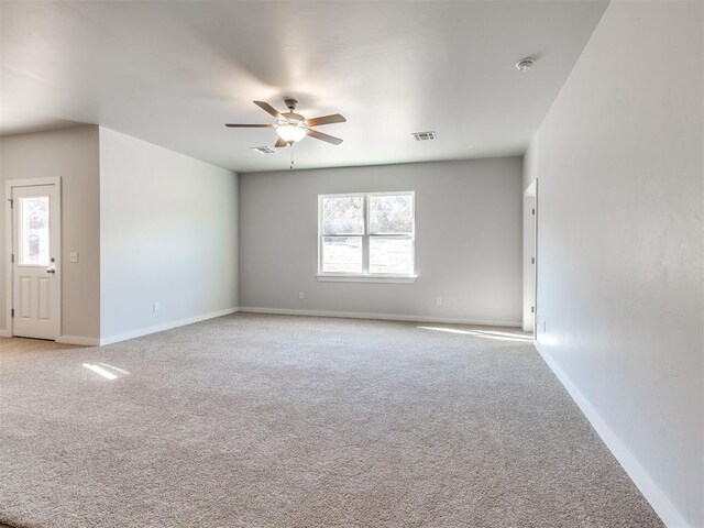 813 Stella Trl, Guthrie, OK 73044 - empty room with a ceiling fan, light colored carpet, baseboards, and a smoke detector
