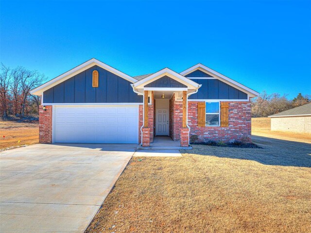 813 Stella Trl, Guthrie, OK 73044 - ranch-style house featuring concrete driveway, board and batten siding, a front yard, and an attached garage