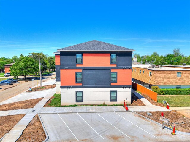 103 E Edwards St, Edmond, OK 73034 - view of front of home with uncovered parking and roof with shingles