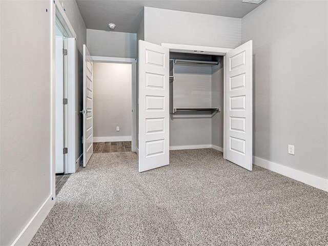 103 E Edwards St, Edmond, OK 73034 - unfurnished bedroom with carpet, a closet, and baseboards