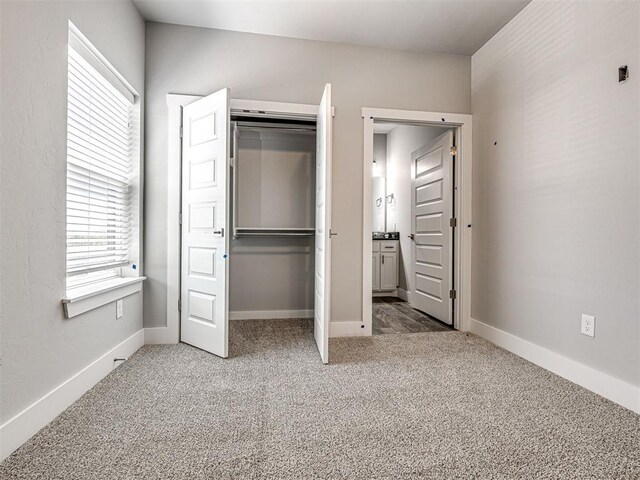 103 E Edwards St, Edmond, OK 73034 - unfurnished bedroom with carpet, a closet, and baseboards