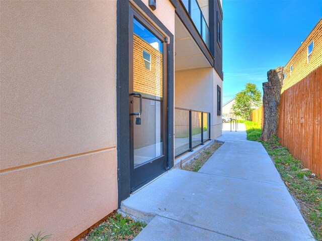103 E Edwards St, Edmond, OK 73034 - doorway to property with stucco siding and a patio area