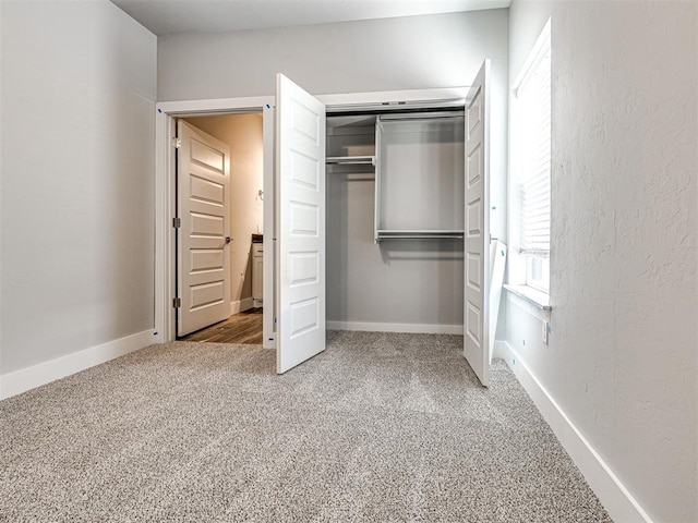 103 E Edwards St, Edmond, OK 73034 - unfurnished bedroom featuring carpet flooring, a closet, and baseboards