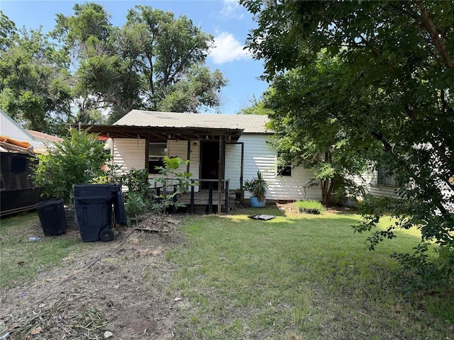 1321 SW 13th St, Oklahoma City, OK 73108 - back of house with a lawn and covered porch