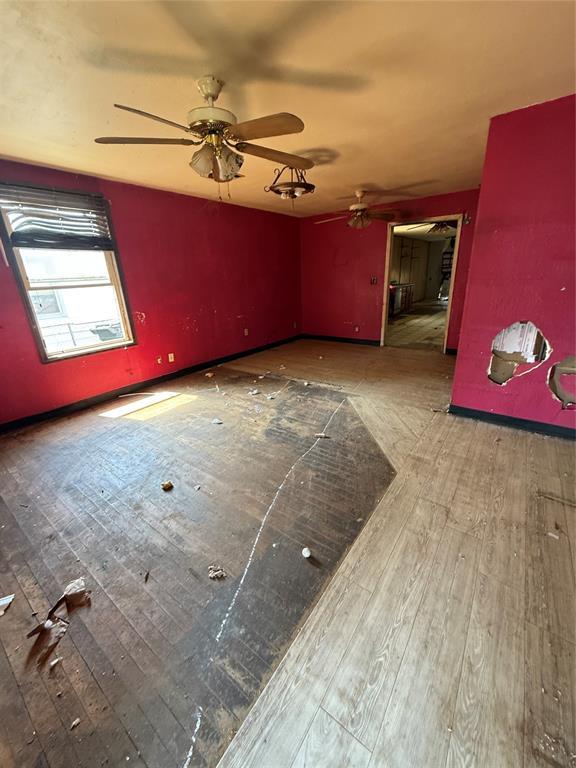 1321 SW 13th St, Oklahoma City, OK 73108 - unfurnished room with hardwood / wood-style floors and a ceiling fan