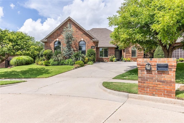 3201 Pinehurst Dr, Norman, OK 73072 - tudor house with brick siding, driveway, and a front lawn