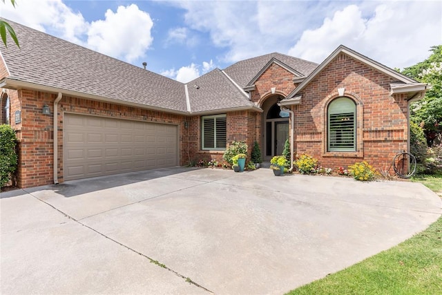 3201 Pinehurst Dr, Norman, OK 73072 - view of front of property featuring brick siding, driveway, and a shingled roof