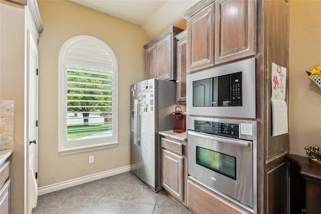 3201 Pinehurst Dr, Norman, OK 73072 - kitchen featuring stainless steel appliances, light tile patterned floors, and light countertops