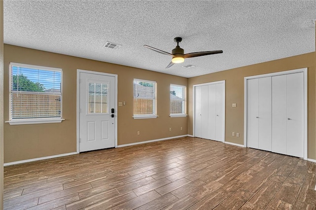 404 Comanche Trl, Altus, OK 73521 - entrance foyer with wood finished floors, ceiling fan, a textured ceiling, and baseboards