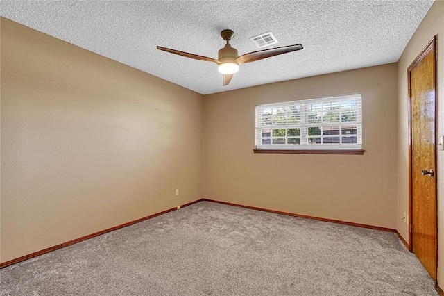 404 Comanche Trl, Altus, OK 73521 - unfurnished room with a ceiling fan, carpet, baseboards, and a textured ceiling