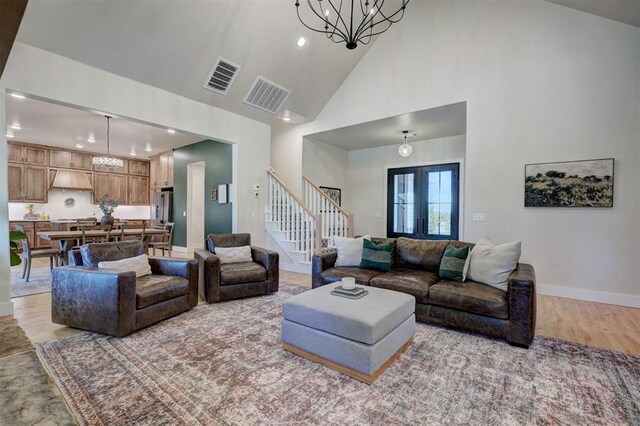612 E Coffee Creek Rd, Edmond, OK 73034 - living room featuring a chandelier, stairway, recessed lighting, high vaulted ceiling, and light wood-style flooring