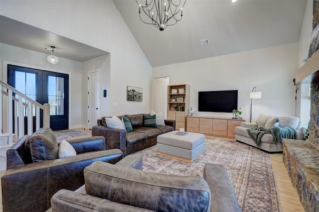 612 E Coffee Creek Rd, Edmond, OK 73034 - living area featuring light wood-type flooring, a chandelier, high vaulted ceiling, baseboards, and french doors