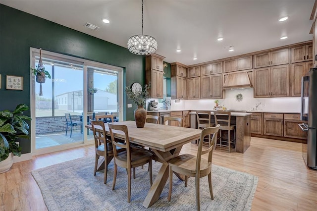 612 E Coffee Creek Rd, Edmond, OK 73034 - dining area featuring light wood finished floors, recessed lighting, and a chandelier