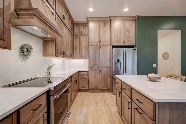 612 E Coffee Creek Rd, Edmond, OK 73034 - kitchen with appliances with stainless steel finishes, custom range hood, light wood-type flooring, tasteful backsplash, and recessed lighting