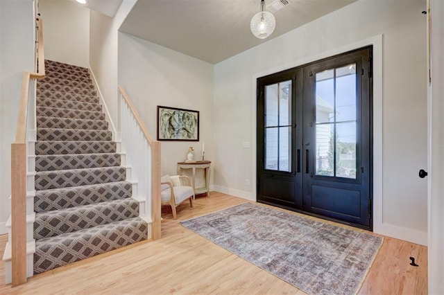 612 E Coffee Creek Rd, Edmond, OK 73034 - foyer entrance with stairway, wood finished floors, baseboards, and french doors