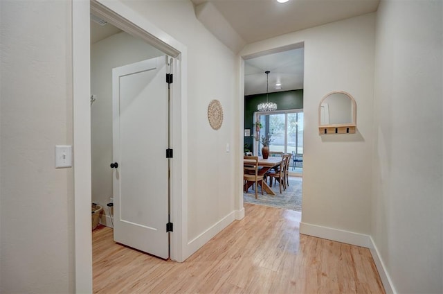 612 E Coffee Creek Rd, Edmond, OK 73034 - hallway with wood finished floors, baseboards, and a chandelier