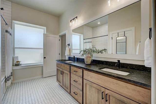 612 E Coffee Creek Rd, Edmond, OK 73034 - full bathroom featuring tiled shower, plenty of natural light, double vanity, and a tub to relax in