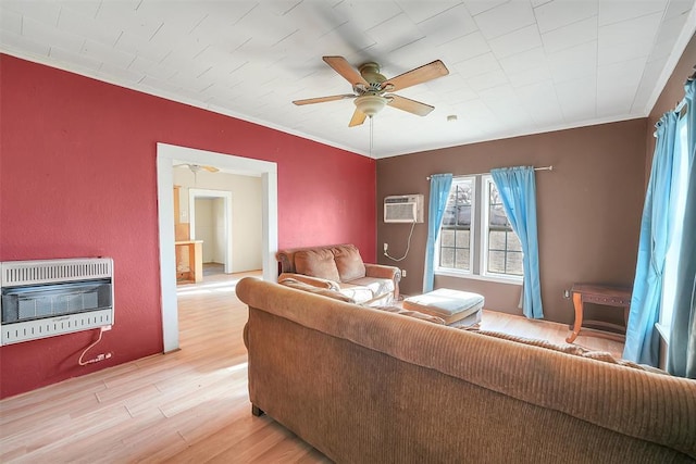 209 E 3rd St, Erick, OK 73645 - living area featuring heating unit, light wood-type flooring, a ceiling fan, and ornamental molding