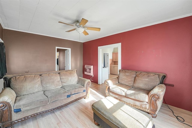 209 E 3rd St, Erick, OK 73645 - living room with heating unit, a ceiling fan, and wood finished floors
