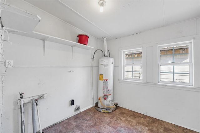 209 E 3rd St, Erick, OK 73645 - laundry room with water heater and hookup for an electric dryer