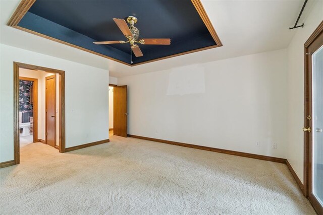4113 Old Farm Rd, Oklahoma City, OK 73120 - unfurnished bedroom with a raised ceiling, light colored carpet, and ceiling fan