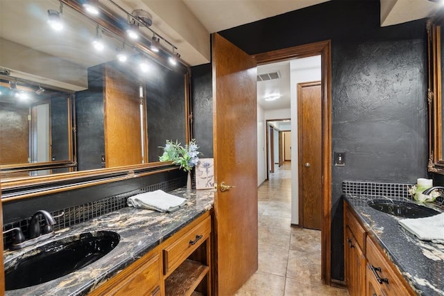 4113 Old Farm Rd, Oklahoma City, OK 73120 - bathroom with vanity, tile patterned flooring, decorative backsplash, and track lighting