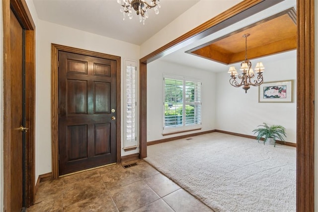 4113 Old Farm Rd, Oklahoma City, OK 73120 - carpeted entryway with a chandelier, tile patterned floors, and a raised ceiling
