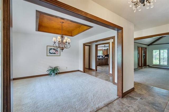 4113 Old Farm Rd, Oklahoma City, OK 73120 - unfurnished dining area with a chandelier, carpet flooring, and a tray ceiling