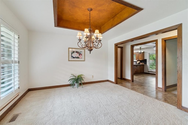 4113 Old Farm Rd, Oklahoma City, OK 73120 - carpeted spare room featuring a chandelier, a raised ceiling, and tile patterned flooring