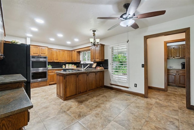 4113 Old Farm Rd, Oklahoma City, OK 73120 - kitchen featuring a peninsula, double oven, ceiling fan, brown cabinets, and dark countertops
