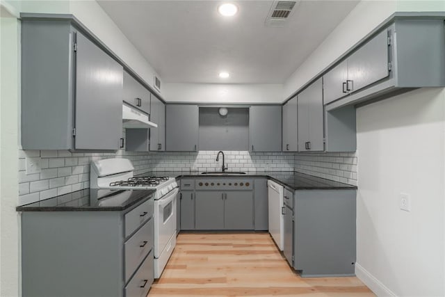 508 S Morrison Ave, El Reno, OK 73036 - kitchen featuring white range with gas stovetop, a sink, dishwashing machine, recessed lighting, and under cabinet range hood