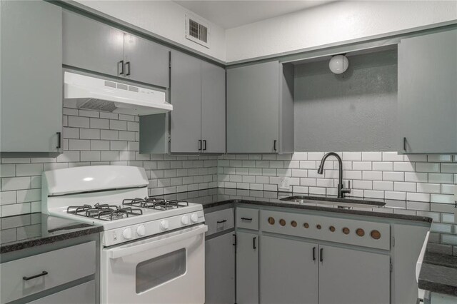 508 S Morrison Ave, El Reno, OK 73036 - kitchen with gas range gas stove, under cabinet range hood, a sink, and gray cabinetry