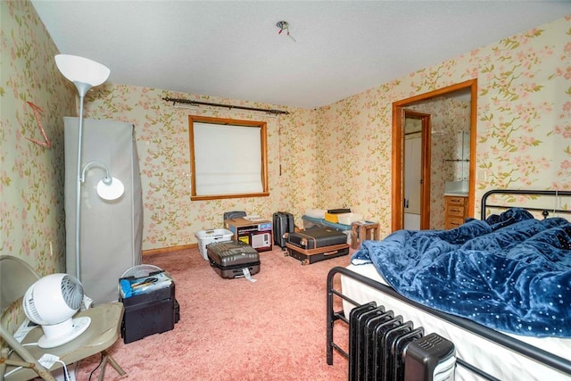 carpeted bedroom with wallpapered walls