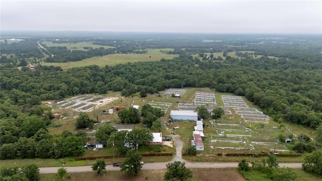 aerial view of property's location featuring a forest