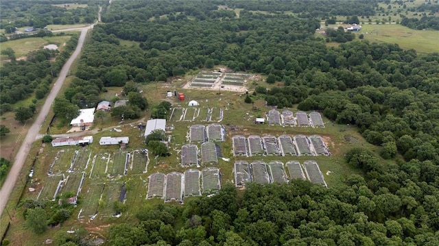 aerial view of property's location featuring a heavily wooded area