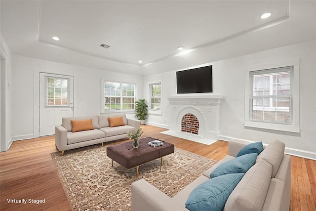 905 NE 21st St, Oklahoma City, OK 73105 - living area with a raised ceiling, light wood-type flooring, healthy amount of natural light, baseboards, and recessed lighting