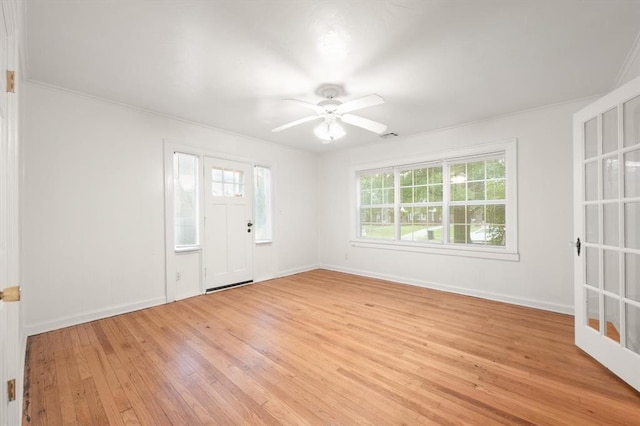905 NE 21st St, Oklahoma City, OK 73105 - entryway with light wood-type flooring, ceiling fan, and baseboards