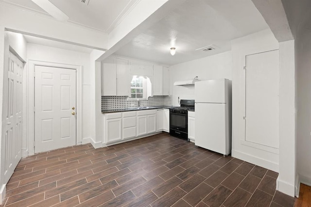 905 NE 21st St, Oklahoma City, OK 73105 - kitchen featuring freestanding refrigerator, gas stove, dark countertops, backsplash, and white cabinetry